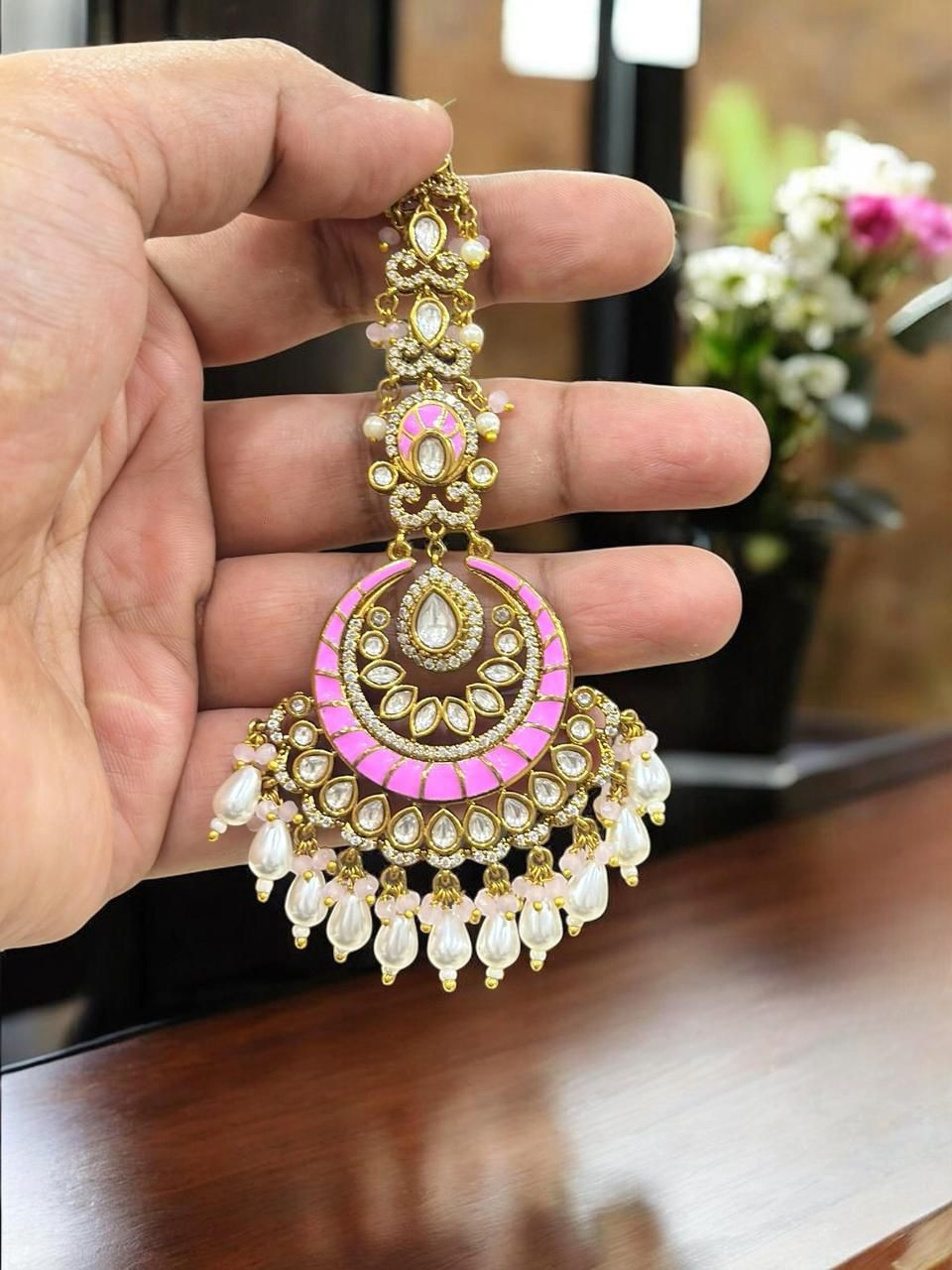 Graceful pink and gold-plated kundan maang tikka adorned with pearls, perfect for bridal and festive looks - Libasaa.com