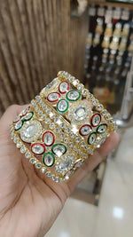 Gold Kundan Bangles with Red-Green Crystal Accents and Stone Detailing - Libasaa.com
