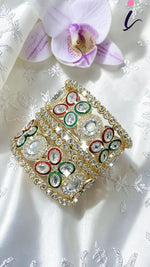 Gold Kundan Bangles with Red-Green Crystal Accents and Stone Detailing